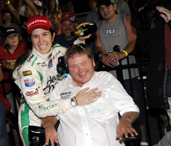 Sam and Ana Beatriz celebrating their win at Iowa Speedway with a traditional champagne drenching
